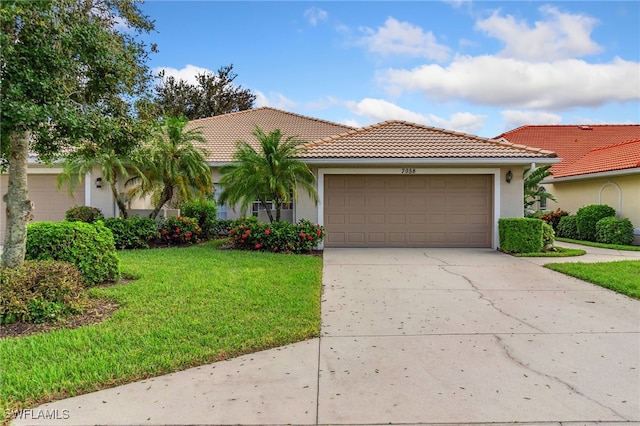 mediterranean / spanish-style home featuring a front yard and a garage