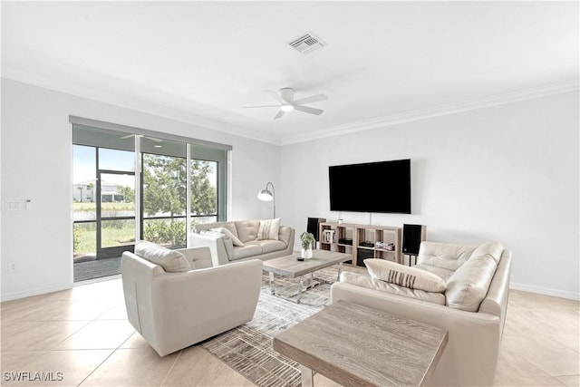 living room with light tile patterned floors, visible vents, ornamental molding, ceiling fan, and baseboards