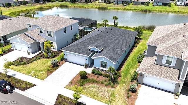 drone / aerial view featuring a water view and a residential view