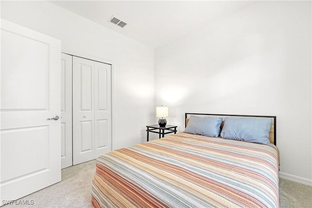 bedroom with a closet, carpet, and visible vents