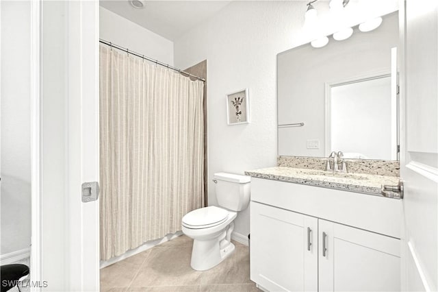 full bath with vanity, toilet, and tile patterned floors