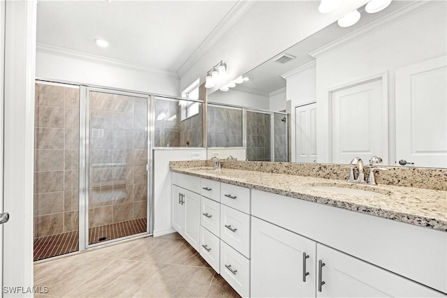 full bathroom featuring a shower stall, a sink, visible vents, and crown molding