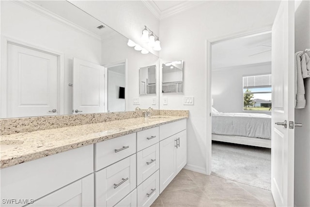 ensuite bathroom with ensuite bathroom, a sink, ornamental molding, tile patterned floors, and double vanity