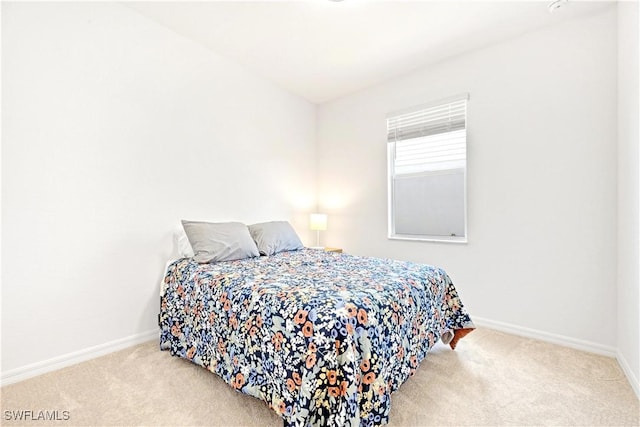 carpeted bedroom featuring baseboards