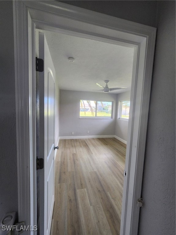 unfurnished room featuring ceiling fan and light hardwood / wood-style flooring