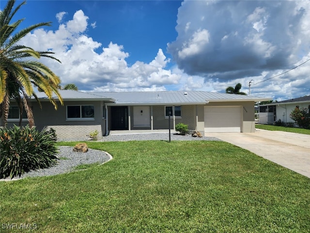 ranch-style house featuring a front lawn and a garage