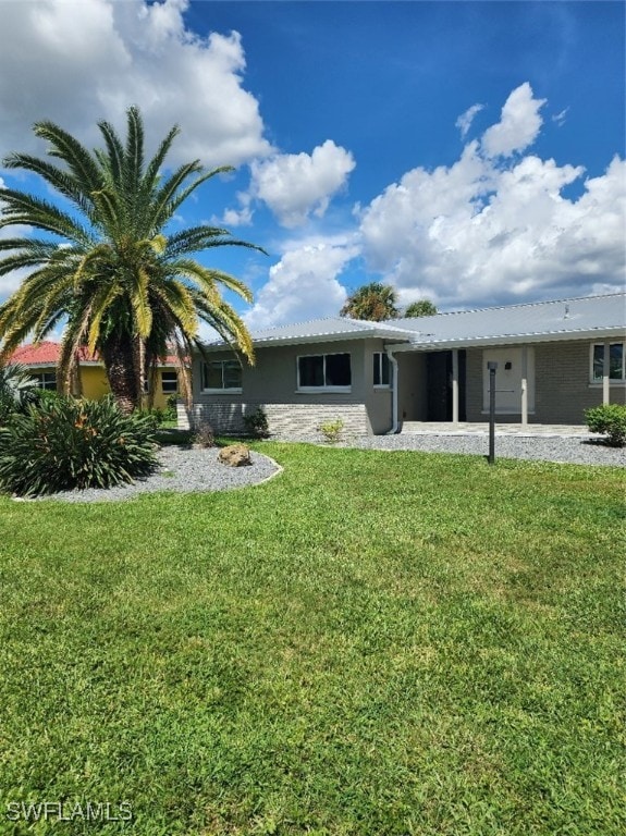 rear view of property featuring a yard