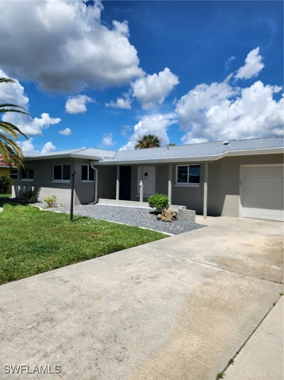 ranch-style house featuring a garage and a front lawn