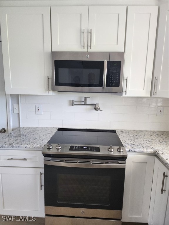 kitchen featuring appliances with stainless steel finishes and white cabinetry