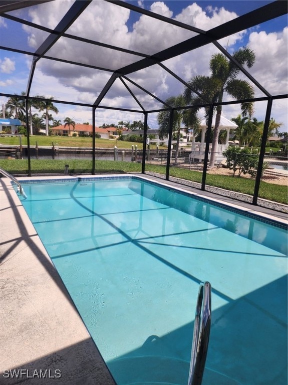 view of swimming pool with glass enclosure