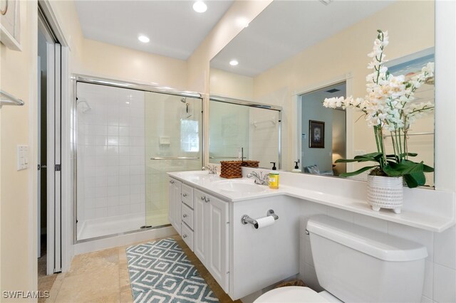 bathroom featuring tile patterned floors, toilet, an enclosed shower, and vanity