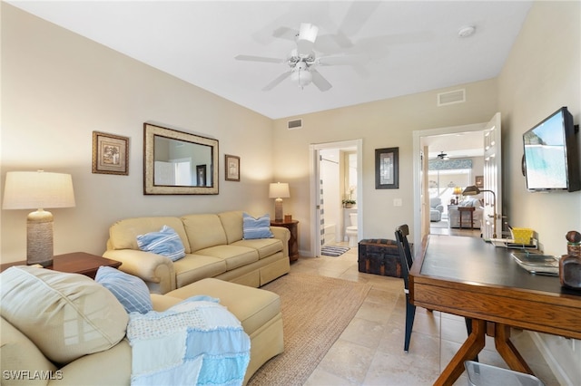 tiled living room with ceiling fan