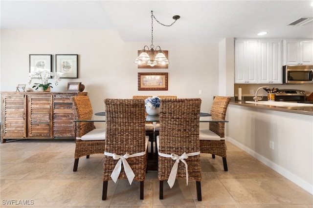 dining room featuring a notable chandelier and sink