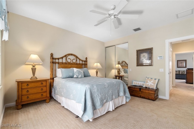 carpeted bedroom featuring ceiling fan and a closet