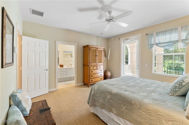 bedroom with connected bathroom, ceiling fan, and light colored carpet