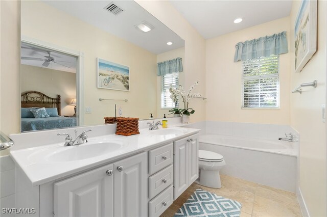 bathroom with ceiling fan, a washtub, tile patterned flooring, toilet, and vanity