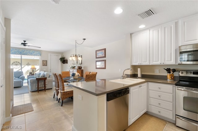 kitchen with kitchen peninsula, white cabinetry, ceiling fan with notable chandelier, and appliances with stainless steel finishes