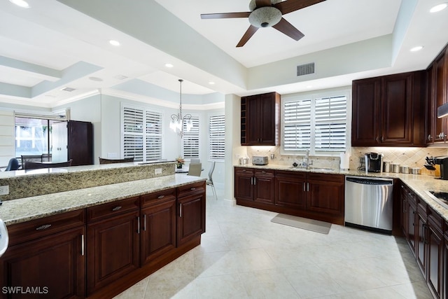 kitchen with a sink, stainless steel dishwasher, a raised ceiling, and decorative backsplash