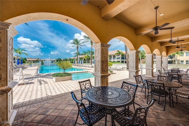 571 Avellino Isles Cir Unit 27102, Naples, FL 34119 - view of patio with ceiling fan, a community pool, and outdoor dining space