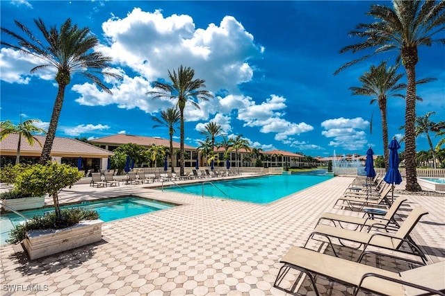 571 Avellino Isles Cir Unit 27102, Naples, FL 34119 - community pool featuring a patio area