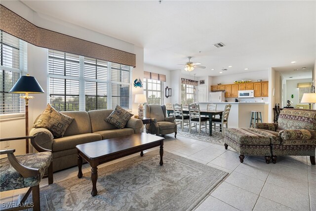 tiled living room with ceiling fan