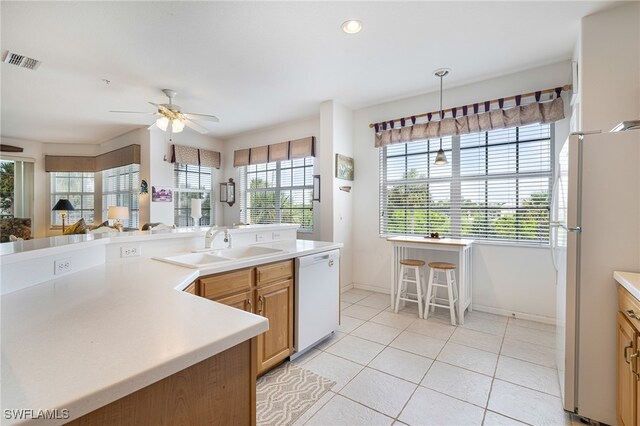 kitchen featuring white appliances, ceiling fan, sink, pendant lighting, and light tile patterned flooring