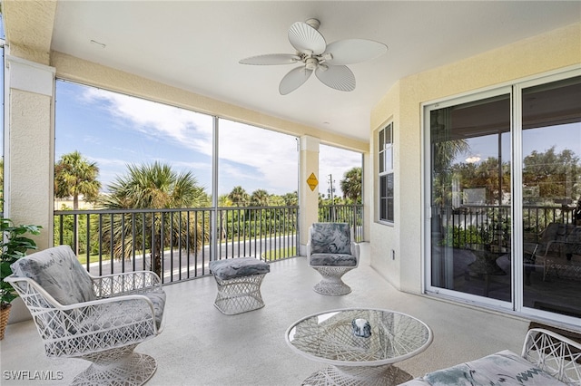 sunroom with a water view and ceiling fan