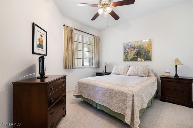 bedroom featuring light colored carpet and ceiling fan