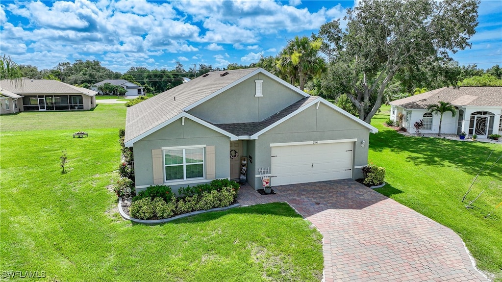 27441 Natal Dr, Punta Gorda, FL 33983 - ranch-style house featuring a front yard and a garage