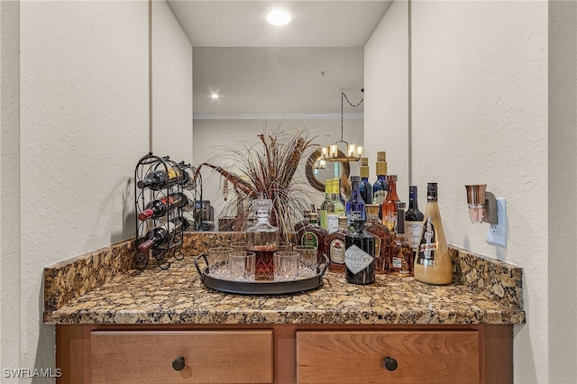 bathroom featuring crown molding, vanity, and a chandelier