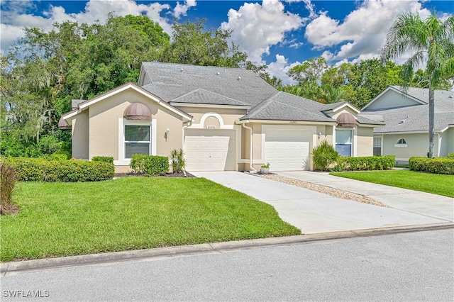 ranch-style house featuring a front yard and a garage