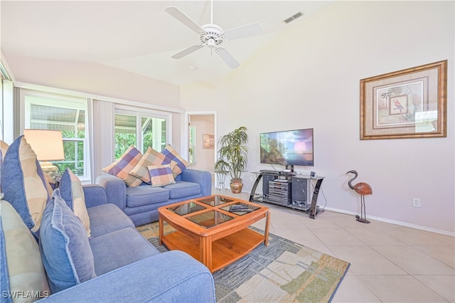 living room featuring vaulted ceiling, light tile patterned floors, and ceiling fan