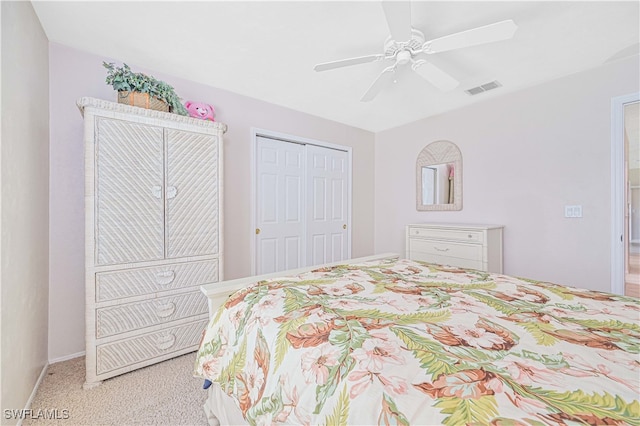 bedroom featuring a closet, light carpet, and ceiling fan