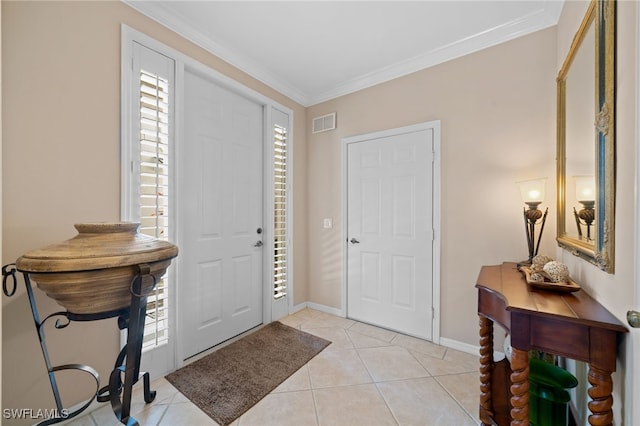 foyer with crown molding, plenty of natural light, and light tile patterned flooring