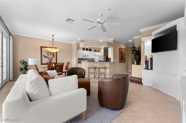 living room featuring ceiling fan, ornamental molding, and light tile patterned floors