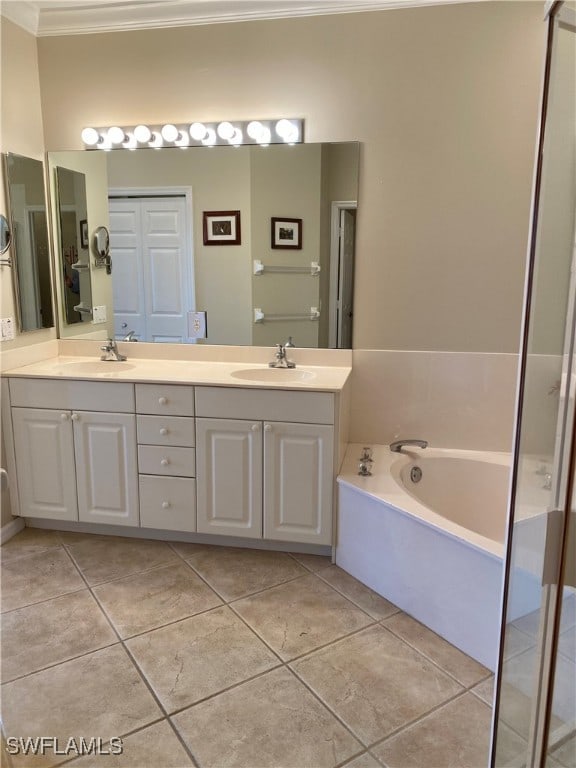 bathroom with ornamental molding, tile patterned flooring, a bathtub, and vanity