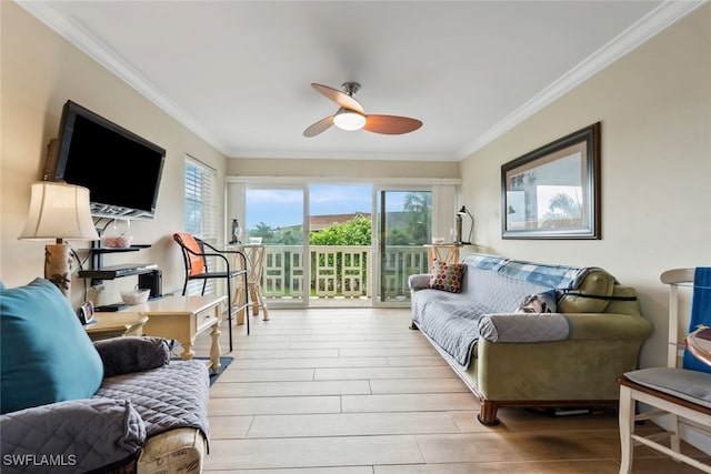 living room featuring crown molding, light hardwood / wood-style floors, and ceiling fan