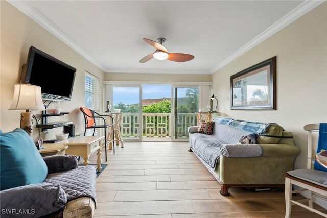 living room featuring light hardwood / wood-style flooring, crown molding, and a healthy amount of sunlight