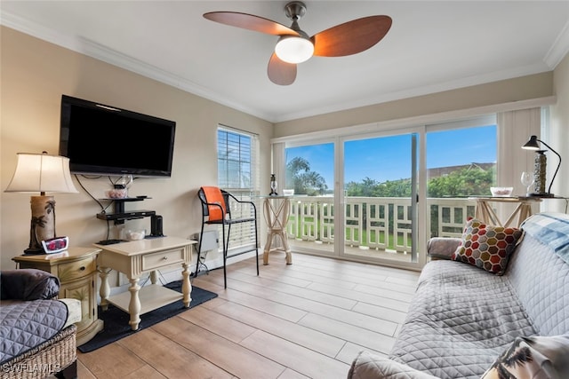 living room with ornamental molding, a wealth of natural light, light hardwood / wood-style floors, and ceiling fan