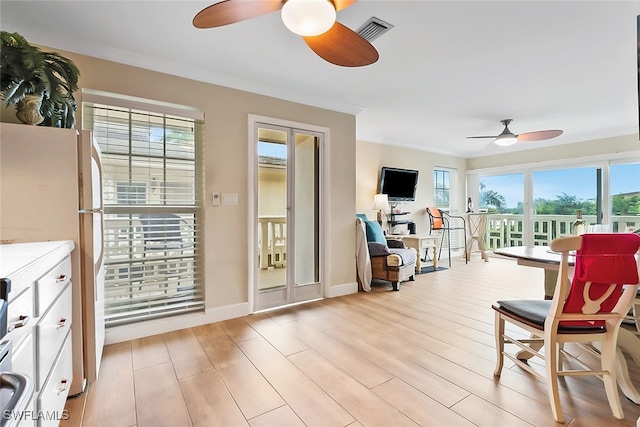 sunroom featuring ceiling fan and a healthy amount of sunlight