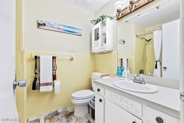 bathroom with tile walls, vanity, a shower with shower curtain, toilet, and tile patterned floors