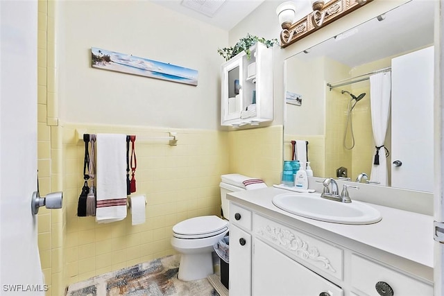 bathroom featuring tile walls, walk in shower, vanity, and toilet