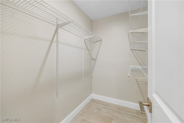 walk in closet with light wood-type flooring