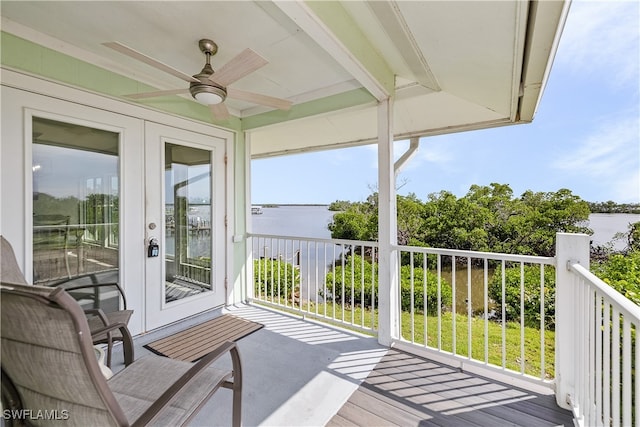 balcony with a water view and ceiling fan