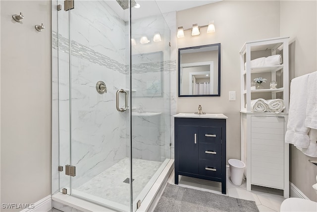 bathroom featuring vanity, toilet, tile patterned floors, and a shower with shower door