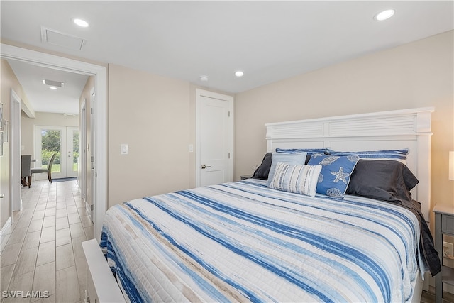 bedroom featuring light wood-type flooring and french doors