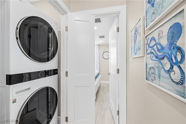 laundry room with stacked washer / dryer