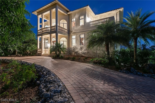 mediterranean / spanish-style home featuring a balcony