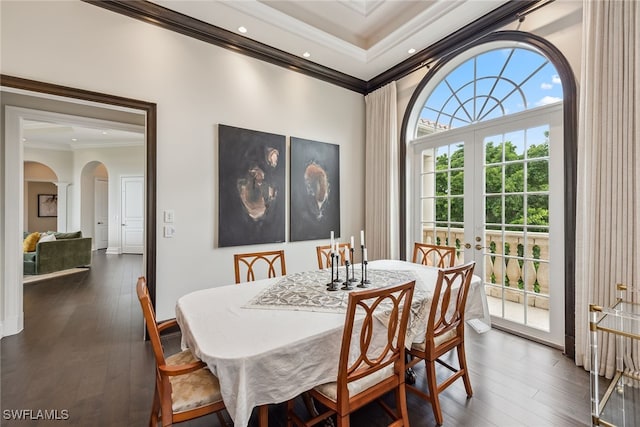 dining space featuring dark hardwood / wood-style floors, crown molding, and french doors