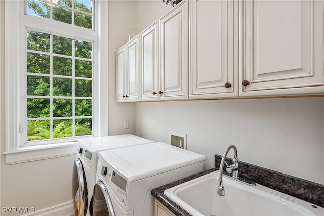 laundry room featuring cabinets, separate washer and dryer, plenty of natural light, and sink